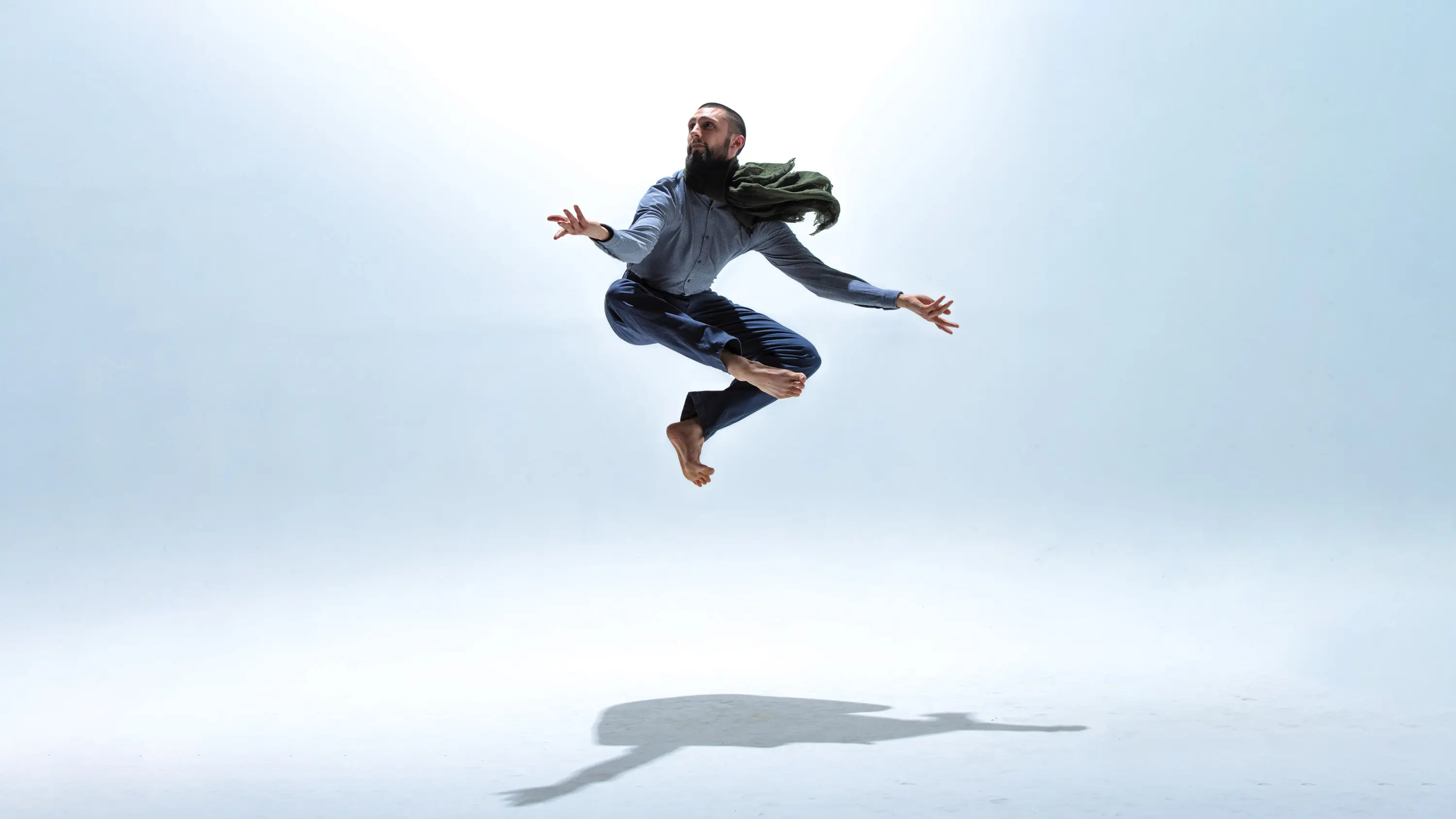 Samuel leaping with a graceful scarf
